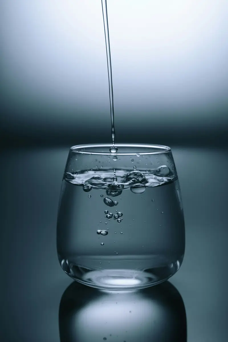 Water pouring into a glass bowl