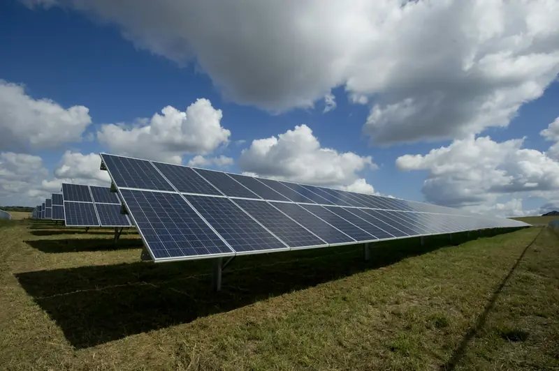 Rows of solar panels under a blue sky
